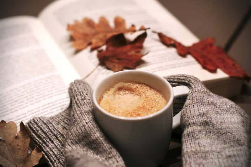 cozy sweater, book, fall leaves and coffee