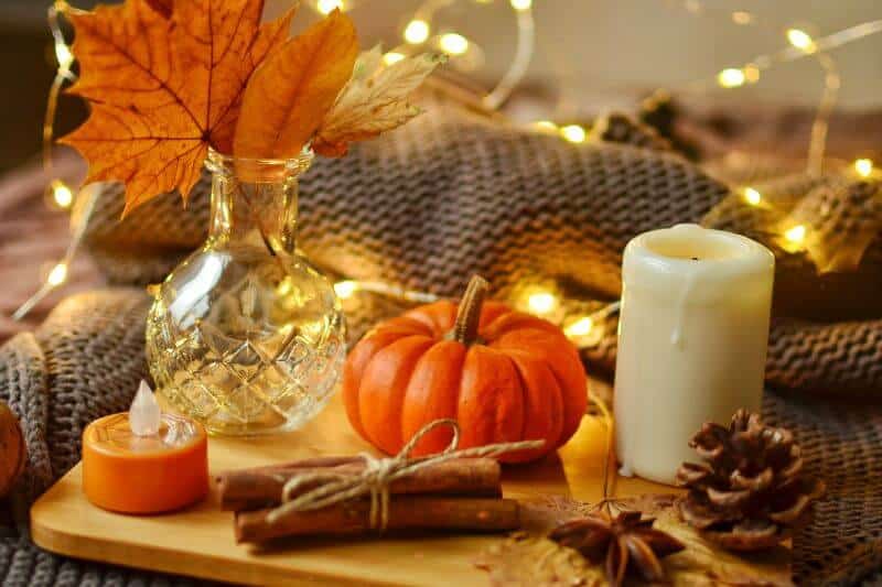 pumpkin, fall leaves, pine cones and candle decorations