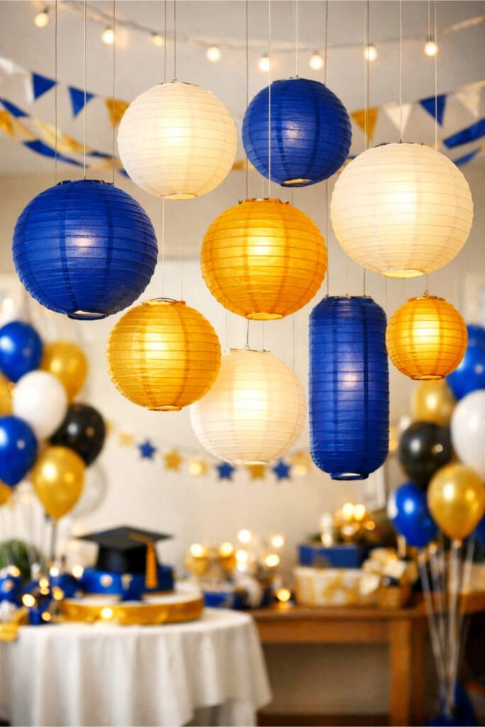 Indoor scene with hanging paper lanterns in school colors decorating a graduation party space.